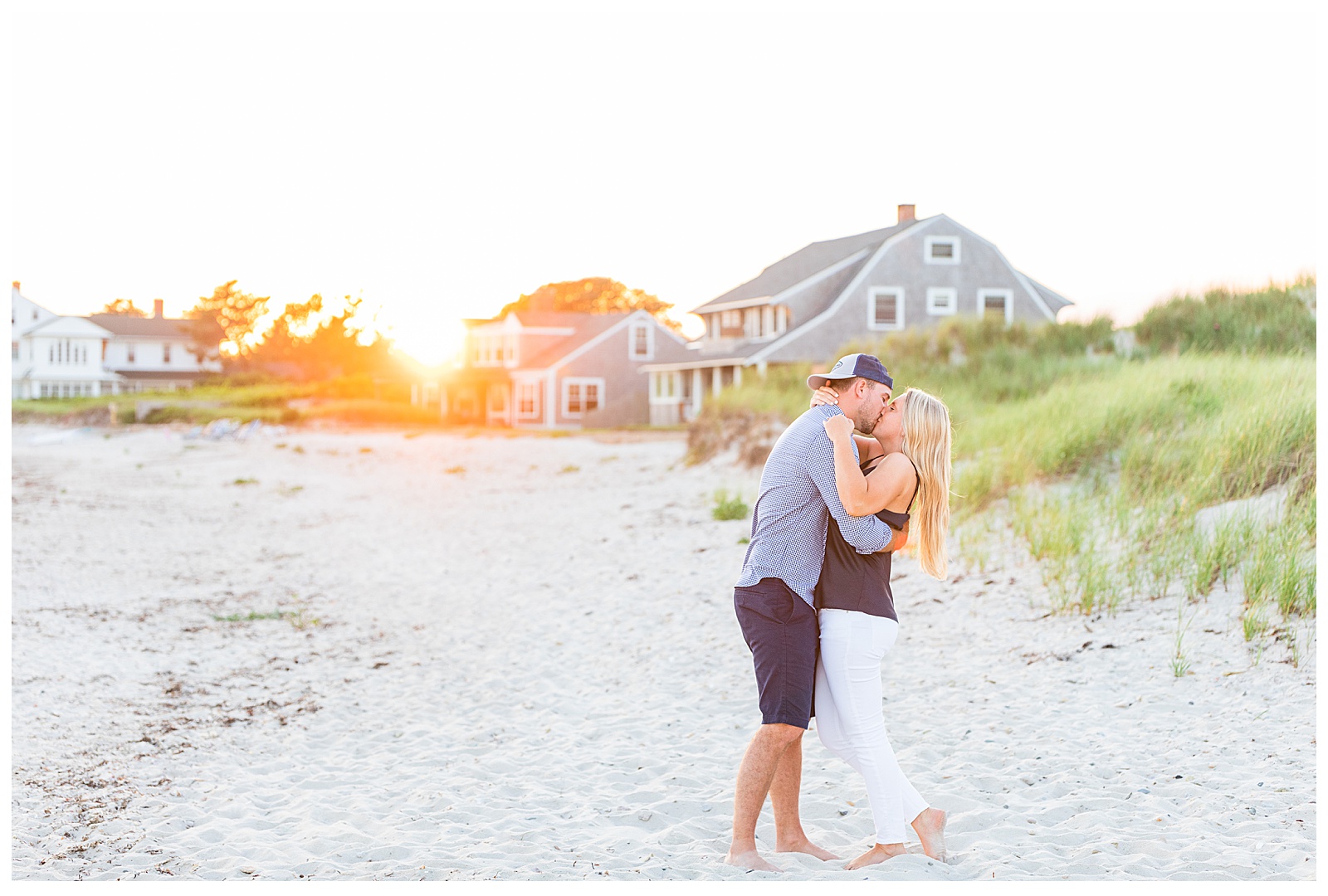 couple kissing with sun haze peeking through