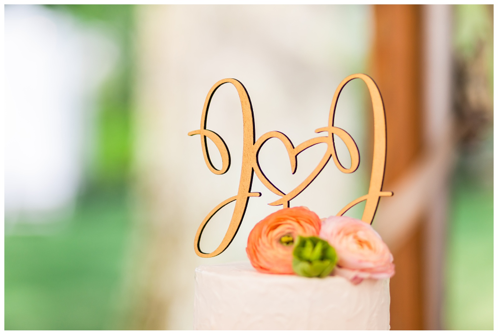 closeup of wedding cake topper. J&J