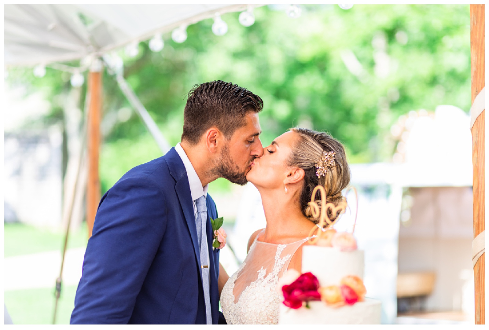 bride and groom kissing after tasting cake