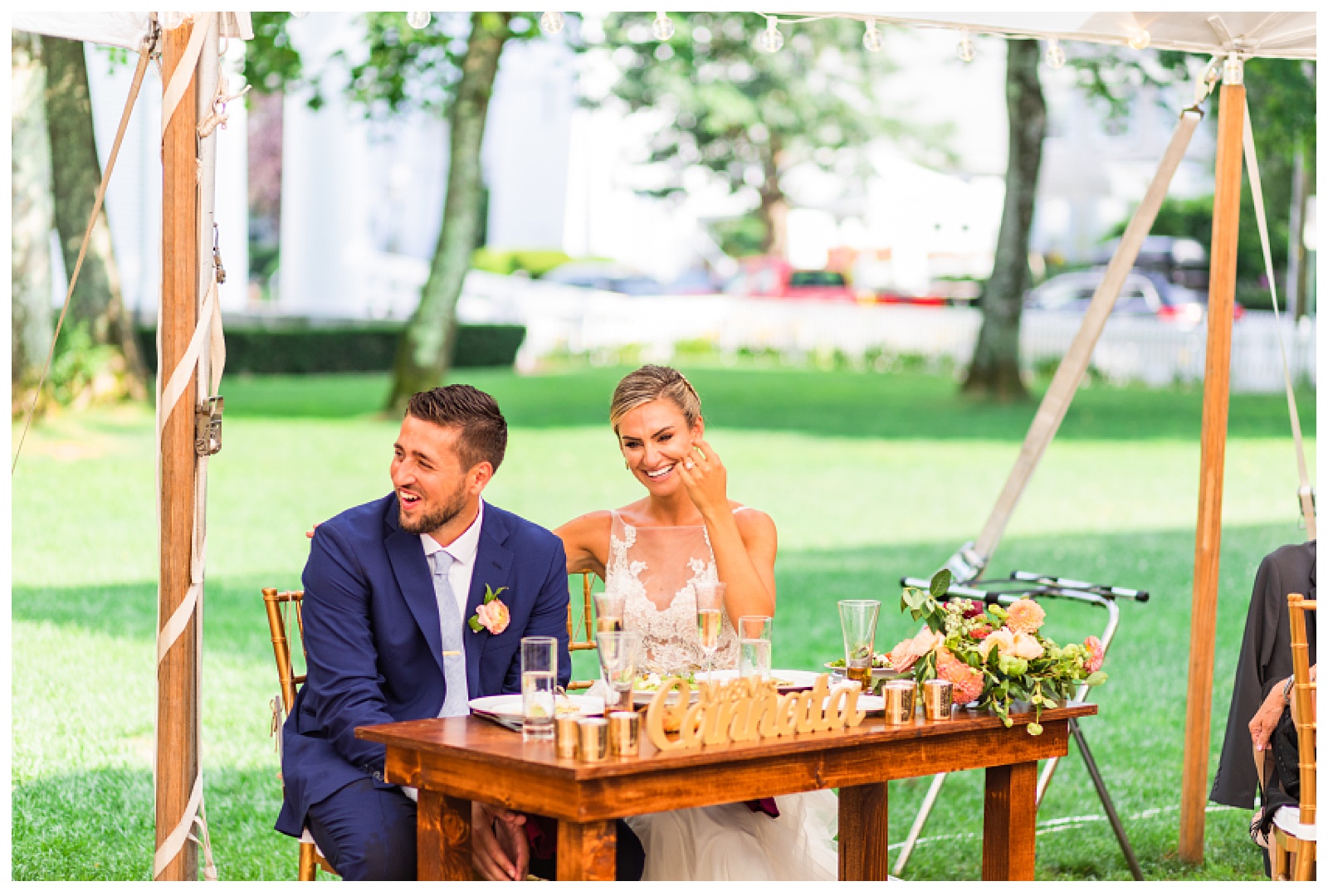 bride and groom laughing at dad's speech