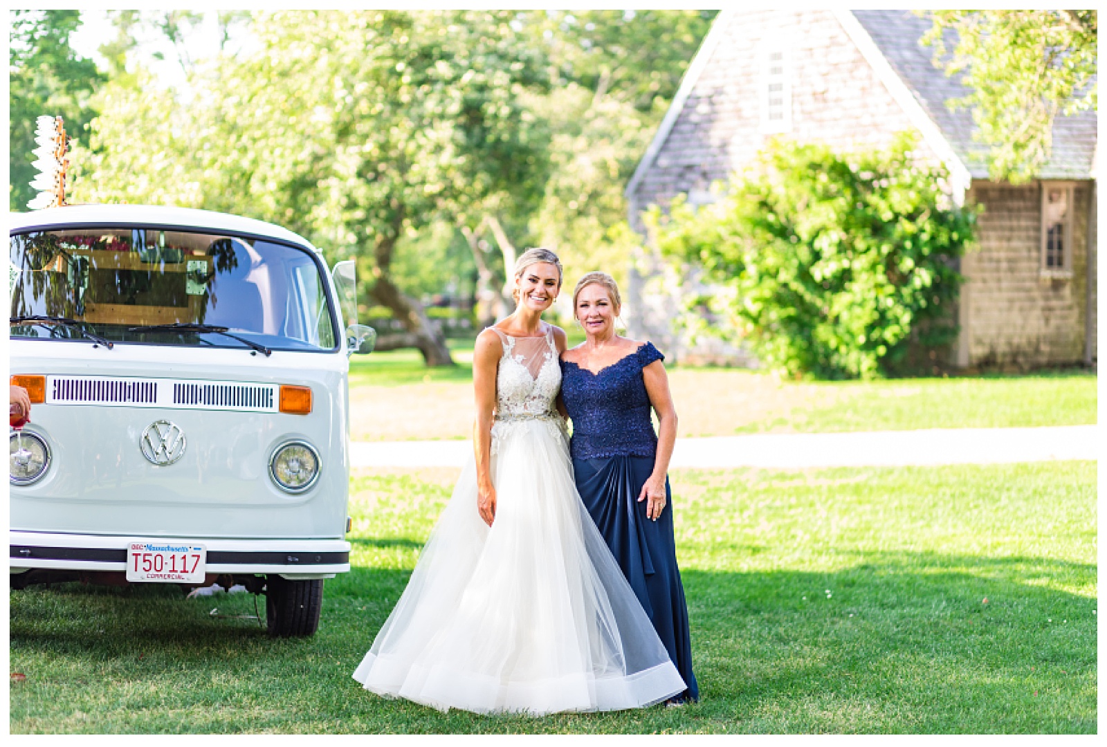 bride and mom standing beside photo booth